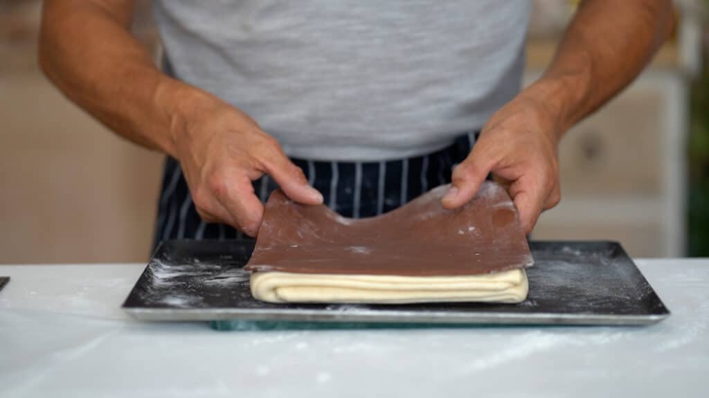 adding colored dough on croissant paton