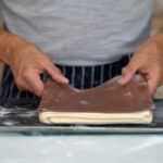 adding colored dough on croissant paton