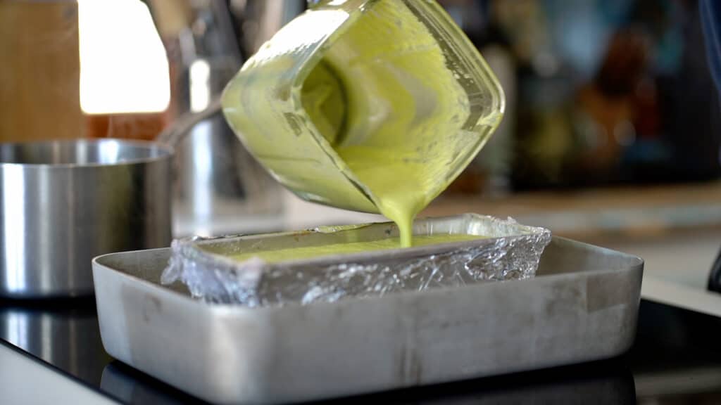 pouring asparagus custard in pan