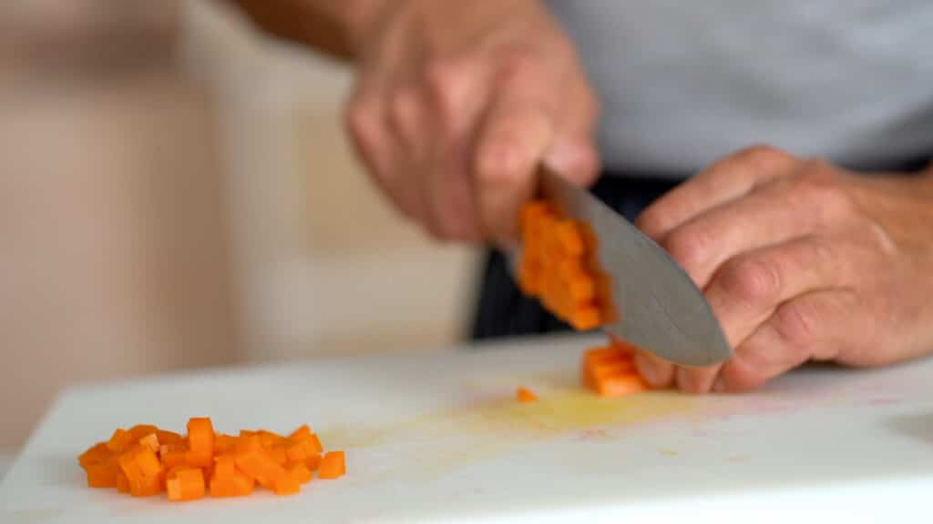 cutting carrots into small cubes