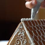 pipping royal icing on gingerbread
