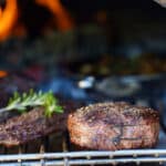 grilling steaks in a wood-fired oven