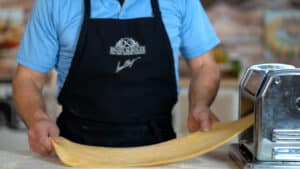 rolling pasta dough in pasta maker