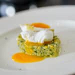 plated poached egg on zucchini brunoise