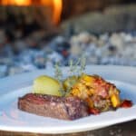 plated ribeye served with ratatouille and potatoes