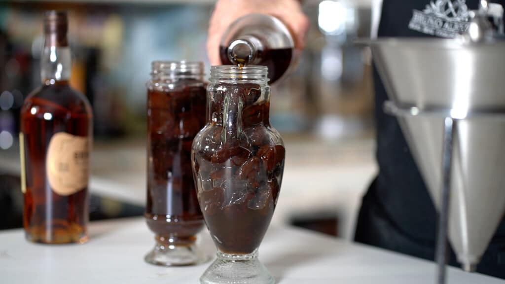 pouring armagnac in prunes