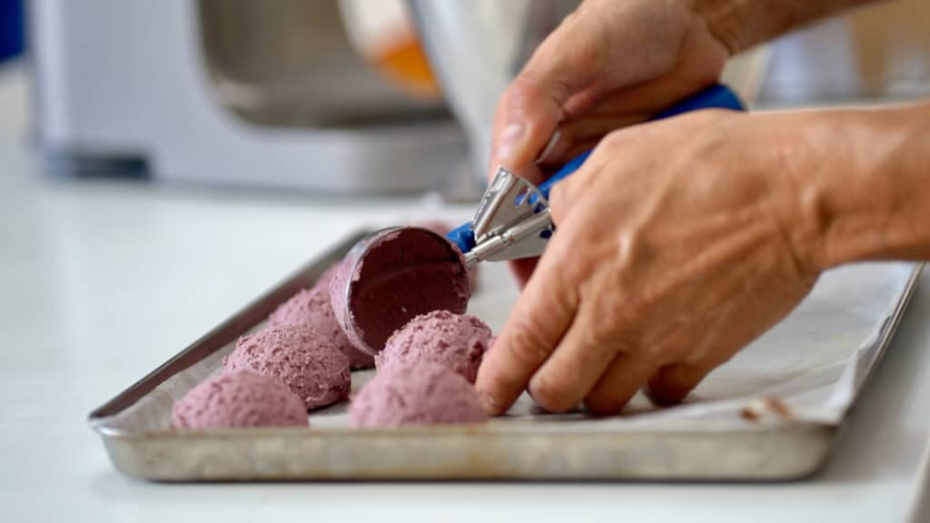 scooping out grape cookie dough