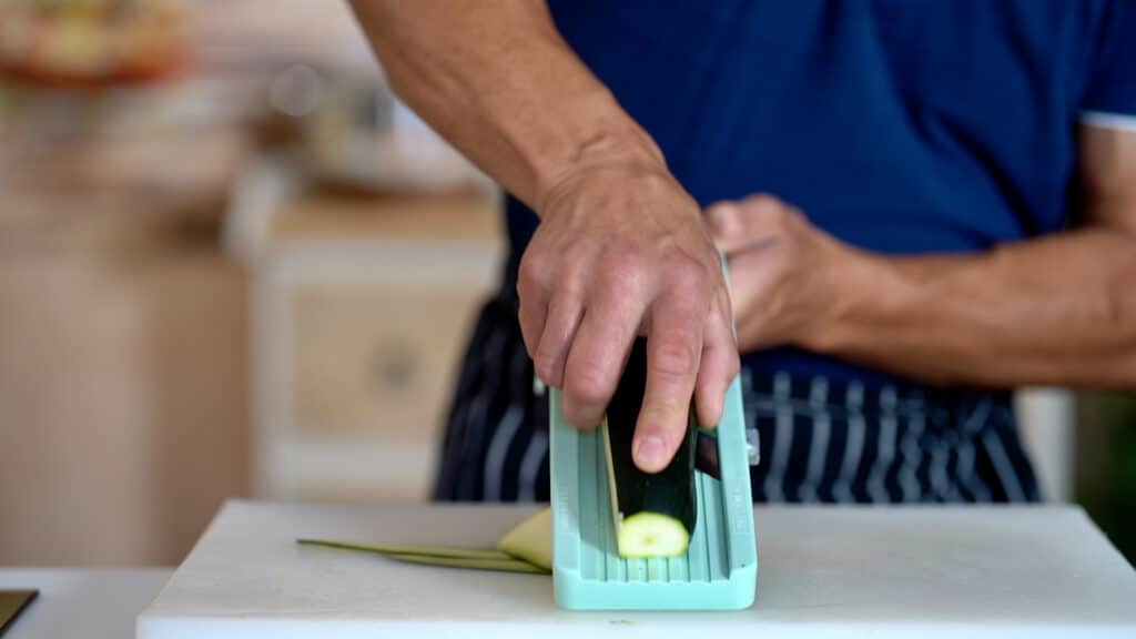 slicing zucchini with a mandoline