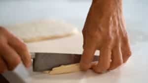 trimming croissant dough